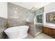 Stunning bathroom with a modern tub, a walk-in shower, gold fixtures, and a large window at 2710 Hedgewood Nw Dr, Atlanta, GA 30311