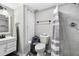 Clean bathroom with a vanity, toilet, and a tiled shower with a curtain at 2710 Hedgewood Nw Dr, Atlanta, GA 30311