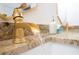 Close-up of a modern gold faucet with water running, complemented by a granite countertop at 2710 Hedgewood Nw Dr, Atlanta, GA 30311