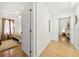 Hallway with hardwood floors leading to a bedroom with a ceiling fan and light at 2710 Hedgewood Nw Dr, Atlanta, GA 30311
