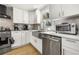 Bright kitchen features white cabinets, stainless steel appliances, and a farmhouse sink at 2710 Hedgewood Nw Dr, Atlanta, GA 30311