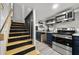 Compact kitchenette with stainless steel appliances, dark blue cabinets, and open shelving at 2710 Hedgewood Nw Dr, Atlanta, GA 30311