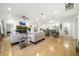 Open-concept living space with fireplace, hardwood floors, and modern furnishings at 2710 Hedgewood Nw Dr, Atlanta, GA 30311