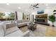 Cozy living room boasts a stylish fireplace, ceiling fan, and large windows at 2710 Hedgewood Nw Dr, Atlanta, GA 30311