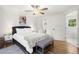 Bright main bedroom with hardwood floors, a grey bench, ensuite bathroom, and natural light at 2710 Hedgewood Nw Dr, Atlanta, GA 30311