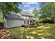 Lovely home exterior featuring a deck, sunroom, and a well-maintained backyard at 3322 Woodsfield Ne Dr, Marietta, GA 30062