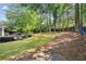 Spacious backyard featuring a lush lawn, mature trees, and a wooden deck for outdoor entertaining at 3322 Woodsfield Ne Dr, Marietta, GA 30062