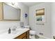 Cozy bathroom features a framed mirror, window and a neutral color palette at 3322 Woodsfield Ne Dr, Marietta, GA 30062