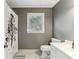 Bathroom featuring a shower with decorative curtain, window, toilet, and vanity at 3322 Woodsfield Ne Dr, Marietta, GA 30062