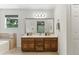 Bright bathroom with double vanity, bathtub and views of nature outside the window at 3322 Woodsfield Ne Dr, Marietta, GA 30062