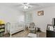 Cozy Bedroom with a white crib, glider chair, plush carpet, and natural light at 3322 Woodsfield Ne Dr, Marietta, GA 30062
