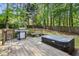 Wooden deck featuring a grill and a hot tub with views of the wooded backyard at 3322 Woodsfield Ne Dr, Marietta, GA 30062