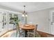 Charming dining room with natural light, hardwood floors, and views of the outdoor deck at 3322 Woodsfield Ne Dr, Marietta, GA 30062