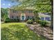 Charming two-story brick home with blue shutters and a well-manicured front yard at 3322 Woodsfield Ne Dr, Marietta, GA 30062