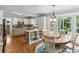 Eat-in kitchen with stainless steel appliances, breakfast area and hardwood floors at 3322 Woodsfield Ne Dr, Marietta, GA 30062