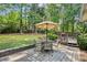 Outdoor patio with a dining table, umbrella, and grill area for entertaining at 3322 Woodsfield Ne Dr, Marietta, GA 30062