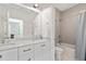 Bright bathroom with double sinks, marble countertops, and a shower-tub combination at 3433 Landen Pine Ne Ct, Atlanta, GA 30305