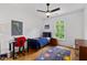 Cozy bedroom features hardwood floors, ceiling fan, and a window view at 3433 Landen Pine Ne Ct, Atlanta, GA 30305