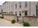 Townhouse patio featuring a brick facade, patio furniture, and manicured landscape at 3433 Landen Pine Ne Ct, Atlanta, GA 30305