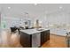 Open floor plan featuring kitchen island with stainless steel dishwasher, and hardwood floors at 3433 Landen Pine Ne Ct, Atlanta, GA 30305