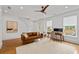 Bright living room featuring hardwood floors, modern furnishings, and large windows with stylish blinds at 3433 Landen Pine Ne Ct, Atlanta, GA 30305