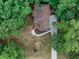 Overhead shot of house with brown roof, surrounded by woods and featuring freshly installed sidewalk and driveway at 1310 Ridgeview Rd, Auburn, GA 30011