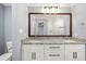 Bathroom featuring double sinks, granite countertops, and a large, framed mirror at 1310 Ridgeview Rd, Auburn, GA 30011