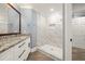 Bathroom featuring double sinks, granite countertops, and a large, tiled shower at 1310 Ridgeview Rd, Auburn, GA 30011