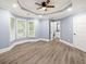 Spacious bedroom with tray ceiling, hardwood floors, and an ensuite bathroom at 1310 Ridgeview Rd, Auburn, GA 30011