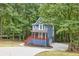 Charming two-story home with a covered porch nestled within a lush, green forest setting at 1310 Ridgeview Rd, Auburn, GA 30011