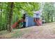 Exterior home view featuring an elevated deck and charming architecture, perfect for enjoying the surrounding wooded scenery at 1310 Ridgeview Rd, Auburn, GA 30011