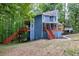 Exterior home featuring an elevated deck, complemented by a lush forest backdrop at 1310 Ridgeview Rd, Auburn, GA 30011