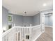 Bright hallway featuring hardwood floors, an open railing, and plenty of light at 1310 Ridgeview Rd, Auburn, GA 30011