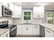 Updated kitchen with granite countertops, white cabinets, and stainless steel appliances at 1310 Ridgeview Rd, Auburn, GA 30011