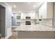 Eat-in kitchen with granite countertops, stainless steel appliances, and modern lighting at 1310 Ridgeview Rd, Auburn, GA 30011