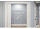 Charming laundry room featuring bi-fold doors and ample shelving for optimal organization at 1310 Ridgeview Rd, Auburn, GA 30011