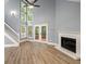 Light filled living room with fire place, high ceilings, modern ceiling fan and wood floors at 1310 Ridgeview Rd, Auburn, GA 30011