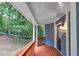 Covered porch with wood railing and forest view at 1310 Ridgeview Rd, Auburn, GA 30011