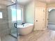 Bathroom featuring free standing tub, walk-in shower and tiled floor at 4050 Sierra Vista Cirs, Cumming, GA 30040