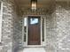 Elegant front door with sidelights, complemented by stylish brickwork and modern outdoor lighting at 4050 Sierra Vista Cirs, Cumming, GA 30040