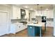 Bright kitchen with white cabinetry, stainless steel appliances, and blue island, perfect for cooking and entertaining at 4050 Sierra Vista Cirs, Cumming, GA 30040