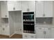 Modern kitchen with sleek stainless steel microwave and oven set, and white cabinets, combining style and functionality at 4050 Sierra Vista Cirs, Cumming, GA 30040