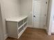 A mudroom with a white cabinet and shelving unit along with a door leading to another room at 4050 Sierra Vista Cirs, Cumming, GA 30040