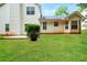 View of the home's backyard featuring a well-maintained lawn, a small patio, and mature landscaping at 4438 Tuckahoe Ct, Douglasville, GA 30135