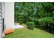 Spacious backyard with a concrete patio and lush greenery, perfect for outdoor living at 4438 Tuckahoe Ct, Douglasville, GA 30135