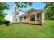 Exterior backyard view of the home surrounded by lush landscaping at 4438 Tuckahoe Ct, Douglasville, GA 30135