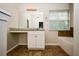 Bathroom features a vanity with a large mirror and a window providing natural light at 4438 Tuckahoe Ct, Douglasville, GA 30135