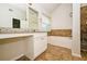 Bathroom features a tub with tiled walls and a vanity area with a large mirror at 4438 Tuckahoe Ct, Douglasville, GA 30135