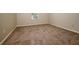 Neutral bedroom with neutral carpet and a window providing natural light at 4438 Tuckahoe Ct, Douglasville, GA 30135