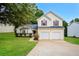 Charming two-story home featuring a well-manicured lawn and a two-car garage at 4438 Tuckahoe Ct, Douglasville, GA 30135